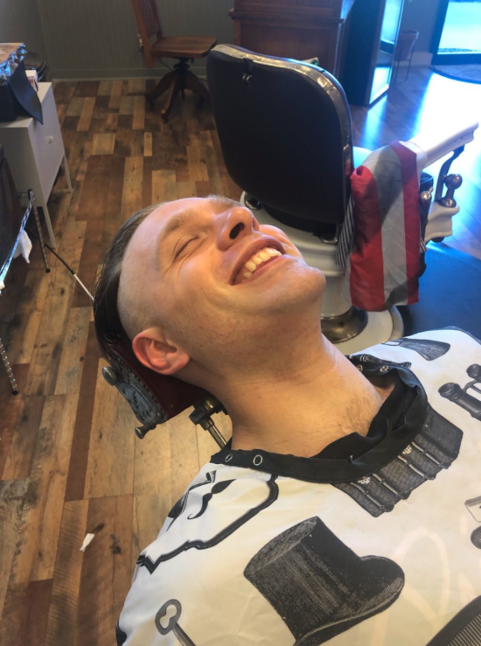 After: the same client, clean-shaven and smiling